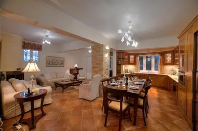 a kitchen and living room with a table and chairs at Lagonisi Villa VIP in Lagonissi