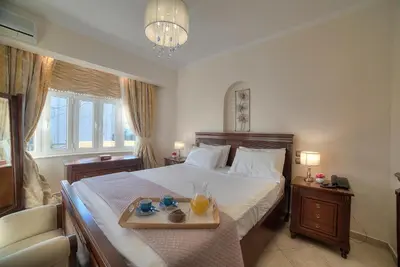 a bedroom with a bed with a tray of food on it at Lagonisi Villa VIP in Lagonissi