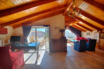 a room with a desk with a computer and chairs at Lagonisi Villa VIP in Lagonissi