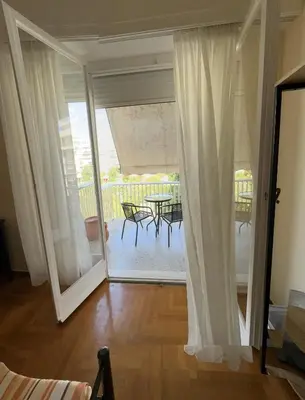 a room with a balcony with a table and chairs at Petaluda House 5 in Athens