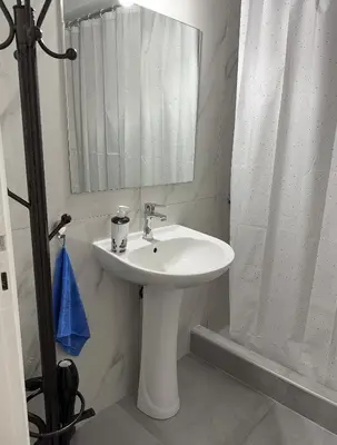 a bathroom with a white sink and a mirror at Petaluda House 5 in Athens