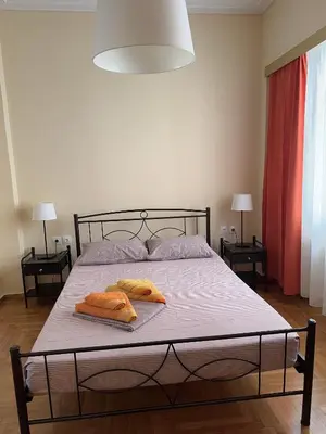 a bedroom with a bed with two towels on it at Petaluda House 5 in Athens