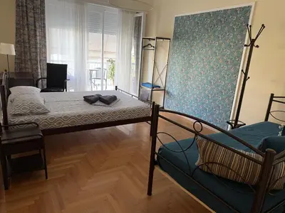 a room with two beds and a couch in it at Petaluda House 5 in Athens