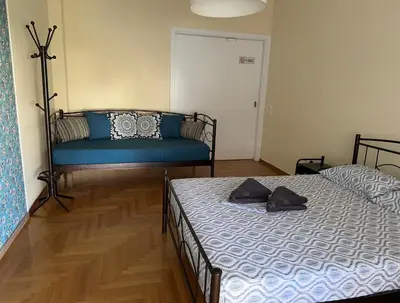 a bedroom with two beds and a couch at Petaluda House 5 in Athens