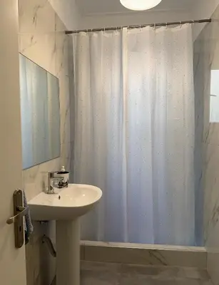 a bathroom with a sink and a shower curtain at Petaluda House 5 in Athens