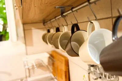 a row of cups and utensils hanging on a wall at Petaluda House 5 in Athens