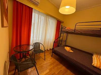 a bedroom with a bunk bed and a table and chairs at Petaluda House 5 in Athens