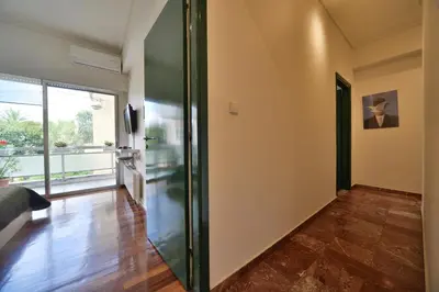 a hallway with a sliding door in a house at Architect Designer's Apartment in Kolonaki in Athens