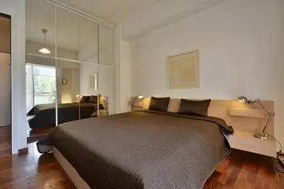 a bedroom with a large bed and a mirror at Architect Designer's Apartment in Kolonaki in Athens