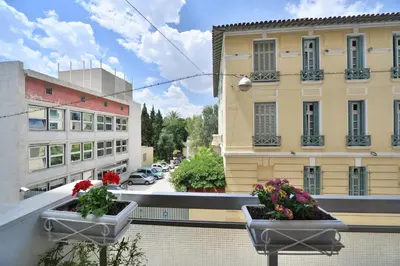 a balcony with two pots of flowers on a building at Architect Designer's Apartment in Kolonaki in Athens