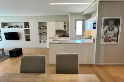 a kitchen and living room with a table and chairs at Central Athens Loft in Athens
