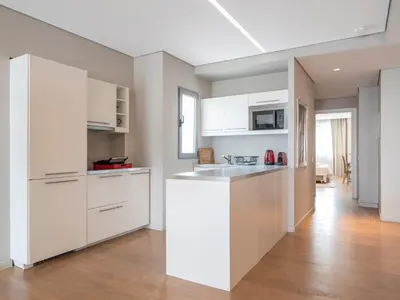 a kitchen with white cabinets and a sink at Central Athens Loft in Athens