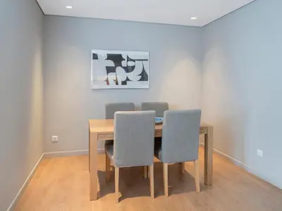 a dining room table with four chairs and a painting at Central Athens Loft in Athens