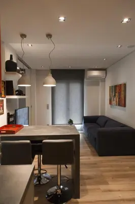 a living room with a table and a couch at Luxury 2 bdrm apartment 10' minutes walk from the Acropolis in Athens