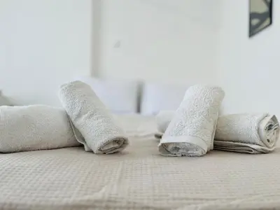 a group of rolled towels on a bed at Elvita Apartments in Athens