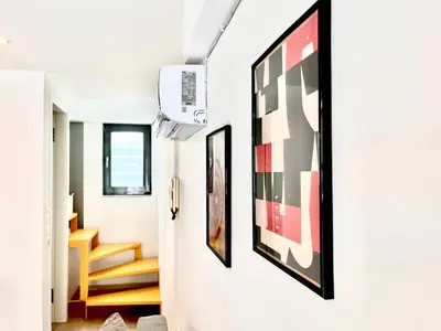 a hallway with framed art on the wall at Elvita Apartments in Athens