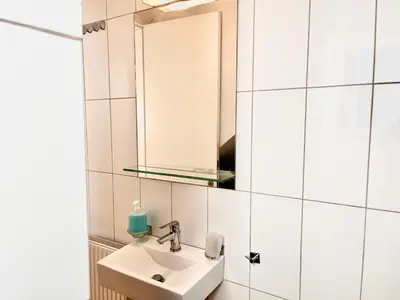 a bathroom with a sink and a mirror at Elvita Apartments in Athens