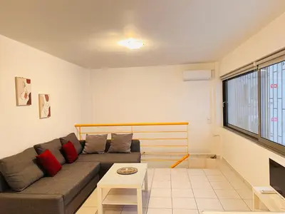 a living room with a couch and a table at Elvita Apartments in Athens