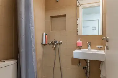 a bathroom with a sink and a toilet and a mirror at Elvita Apartments in Athens