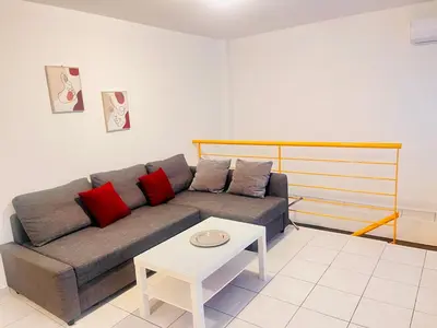 a living room with a couch and a table at Elvita Apartments in Athens