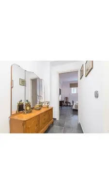 a room with a mirror and a wooden dresser at Koukaki Home in Athens