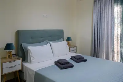 a bedroom with a bed with two towels on it at Koukaki Home in Athens