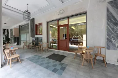 a restaurant with tables and chairs and windows at Meni Apartments in Athens