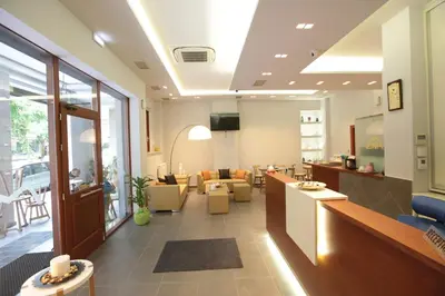 a lobby with a waiting room with couches at Meni Apartments in Athens