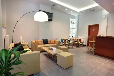 a living room with couches and a table and chairs at Meni Apartments in Athens