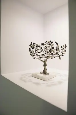 a sculpture of a flower on a white table at GK Athens by GK Properties in Athens