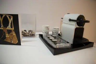 a black and white coffee maker and cups on a counter at GK Athens by GK Properties in Athens