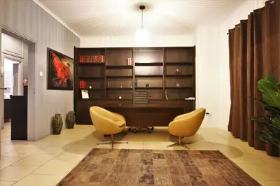 an office with a desk and two yellow chairs at GK Athens by GK Properties in Athens
