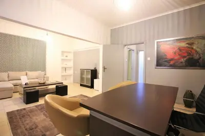 a living room with a table and a couch at GK Athens by GK Properties in Athens