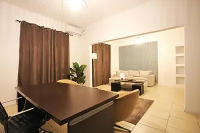 a living room with a table and a couch at GK Athens by GK Properties in Athens