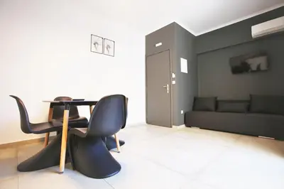 a living room with a table and chairs and a couch at GK Athens by GK Properties in Athens
