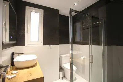 a bathroom with a toilet and a glass shower at GK Athens by GK Properties in Athens