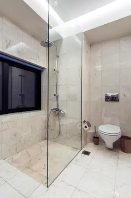 a bathroom with a glass shower with a toilet at Hidden Sanctuary In Saronida in Anavissos