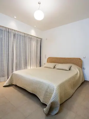 a bedroom with a large bed in a room at Hidden Sanctuary In Saronida in Anavissos