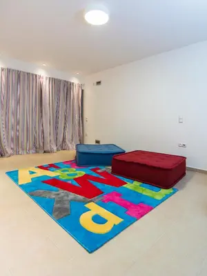 a room with a colorful rug on the floor at Hidden Sanctuary In Saronida in Anavissos