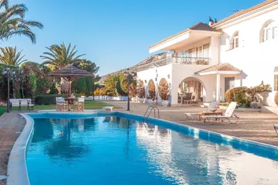 a swimming pool in front of a house at Villa Noaina in Lagonissi in Lagonissi