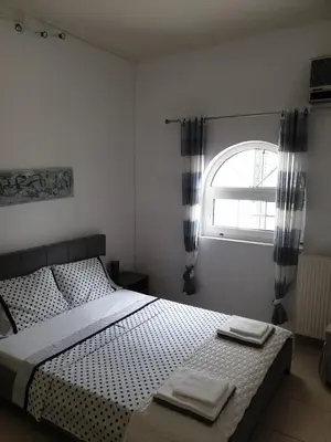 a bedroom with a bed with two towels on it at Villa Noaina in Lagonissi in Lagonissi
