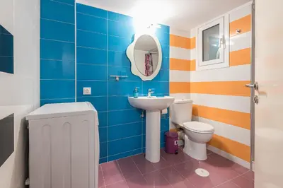 a bathroom with a sink and a toilet at Zenios Amintas-Pop-artment for two in city center in Athens