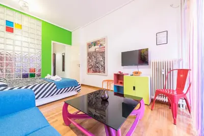 a living room with a couch and a table at Zenios Amintas-Pop-artment for two in city center in Athens