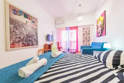 a bedroom with a large bed with towels on it at Zenios Amintas-Pop-artment for two in city center in Athens