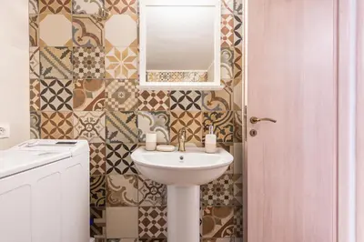 a bathroom with a sink and a mirror at Zenios Hercules - Stylish apartment near Acropolis in Athens