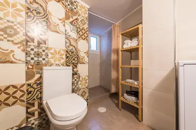 a bathroom with a toilet in a room at Zenios Hercules - Stylish apartment near Acropolis in Athens