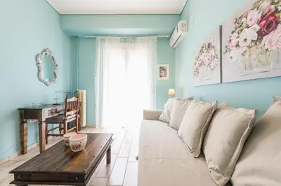 a living room with a couch and a table at Zenios Hercules - Stylish apartment near Acropolis in Athens
