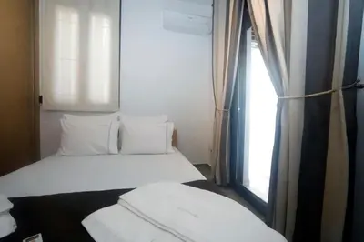 a small bedroom with a bed and a window at Gazi Boutique Apartment 1 in Athens