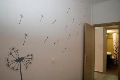 a wall with dandelions on the wall at Gazi Boutique Apartment 1 in Athens