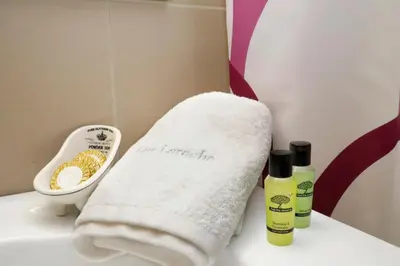 a towel on a bathroom counter with two bottles of soap at Gazi Boutique Apartment 1 in Athens